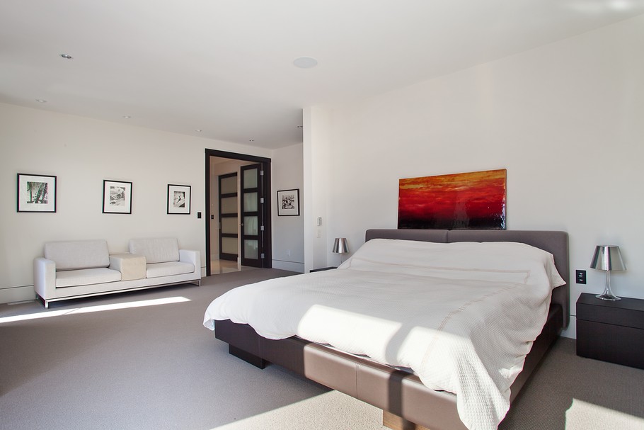 White Quilt near the White Sofa on Grey Floor in Chalet