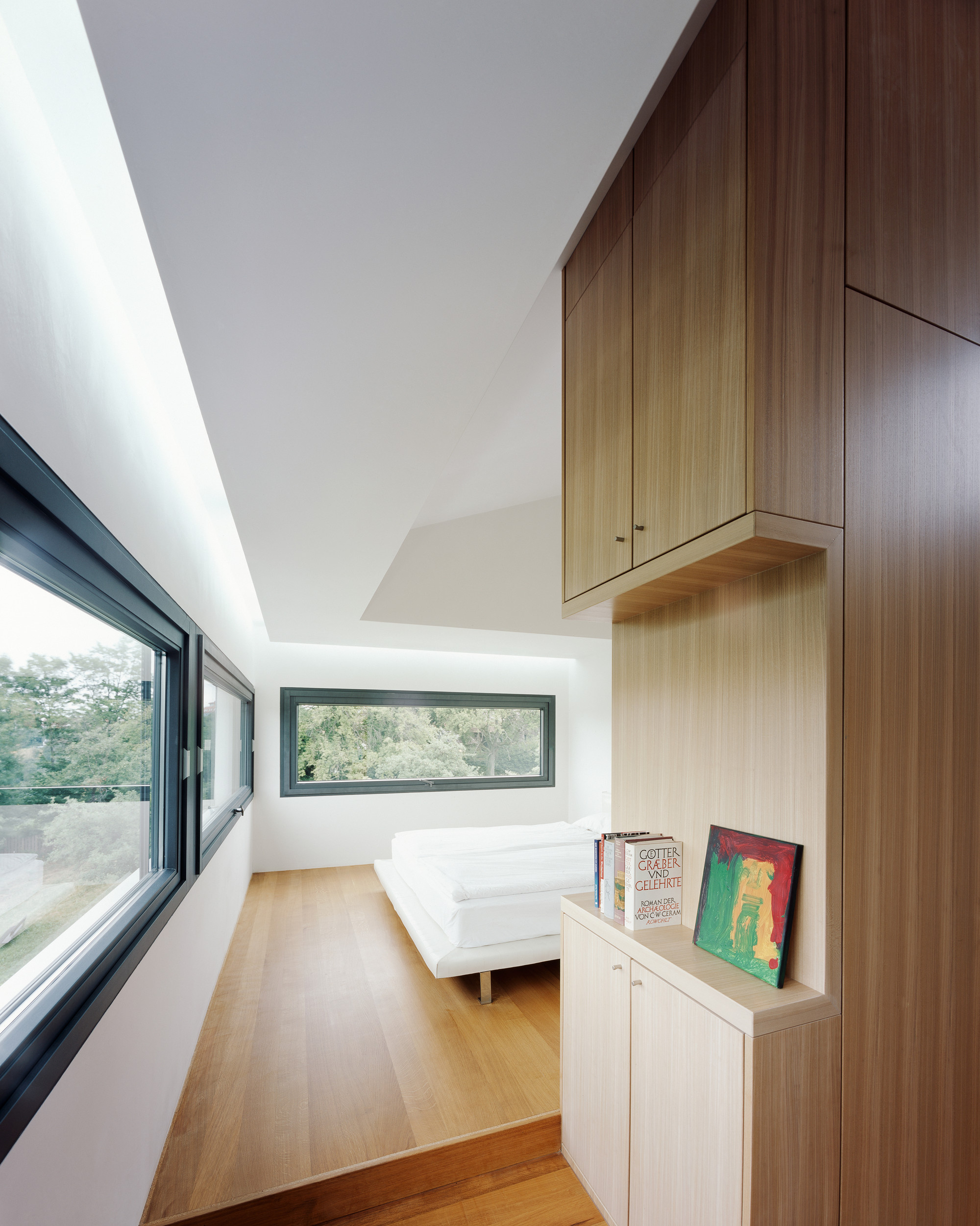 Bedroom Area Among Hardwood Flooring under House Anna Philipp under That Wooden Storage Showed Books Area