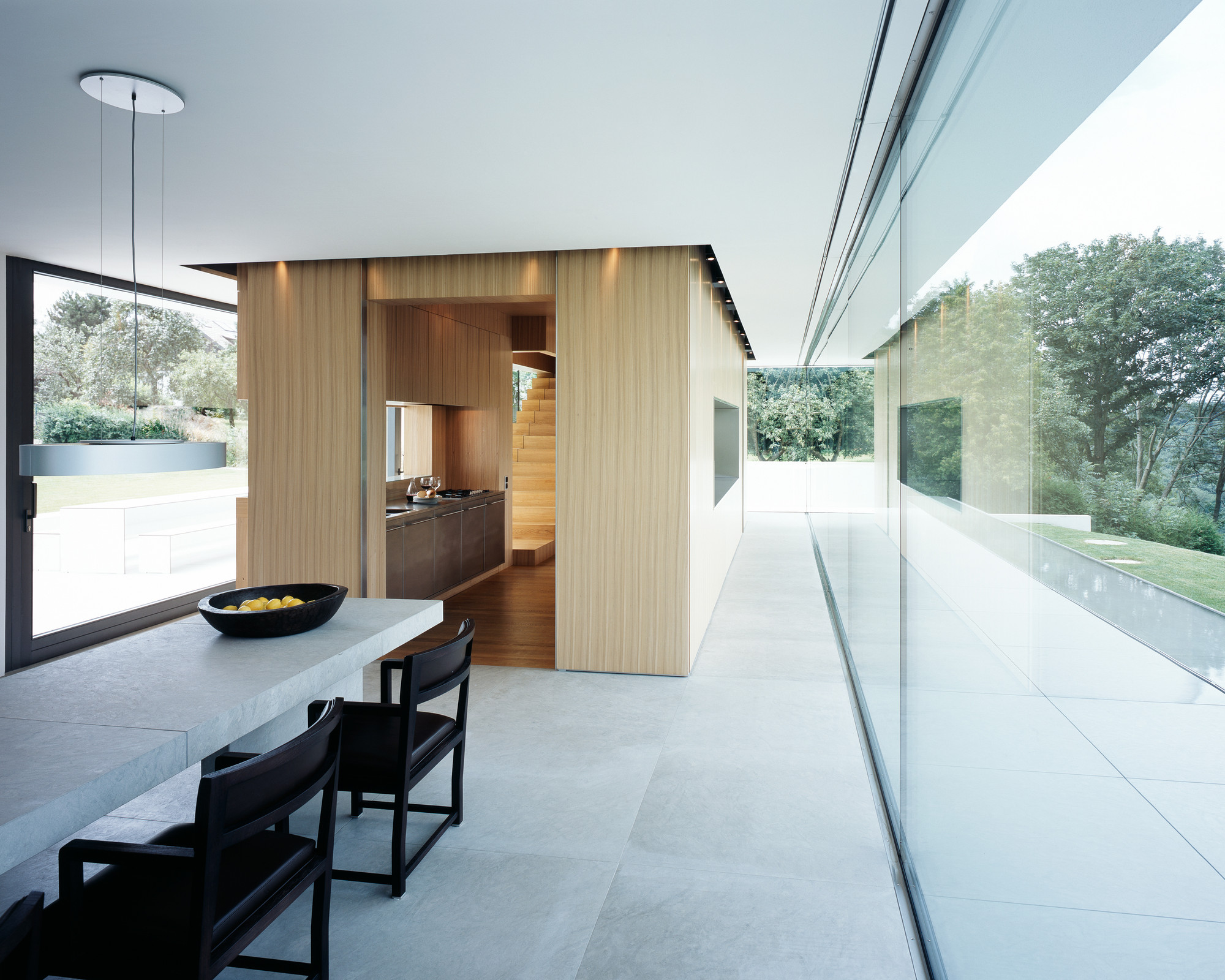 House Anna Philipp Interior Area Showing Dark Chairs Facing Steel Table Fruits Finished On The Bottom from Chandelier