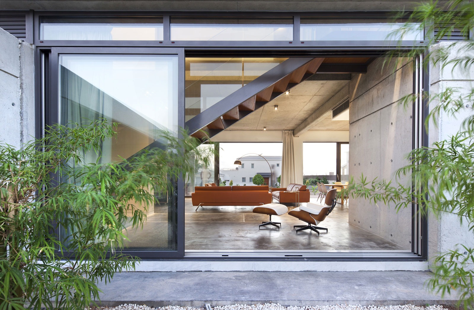 Andri & Yiorgos Residence - Windows From Glass Panels With Black Borders Also Green Plants Garden