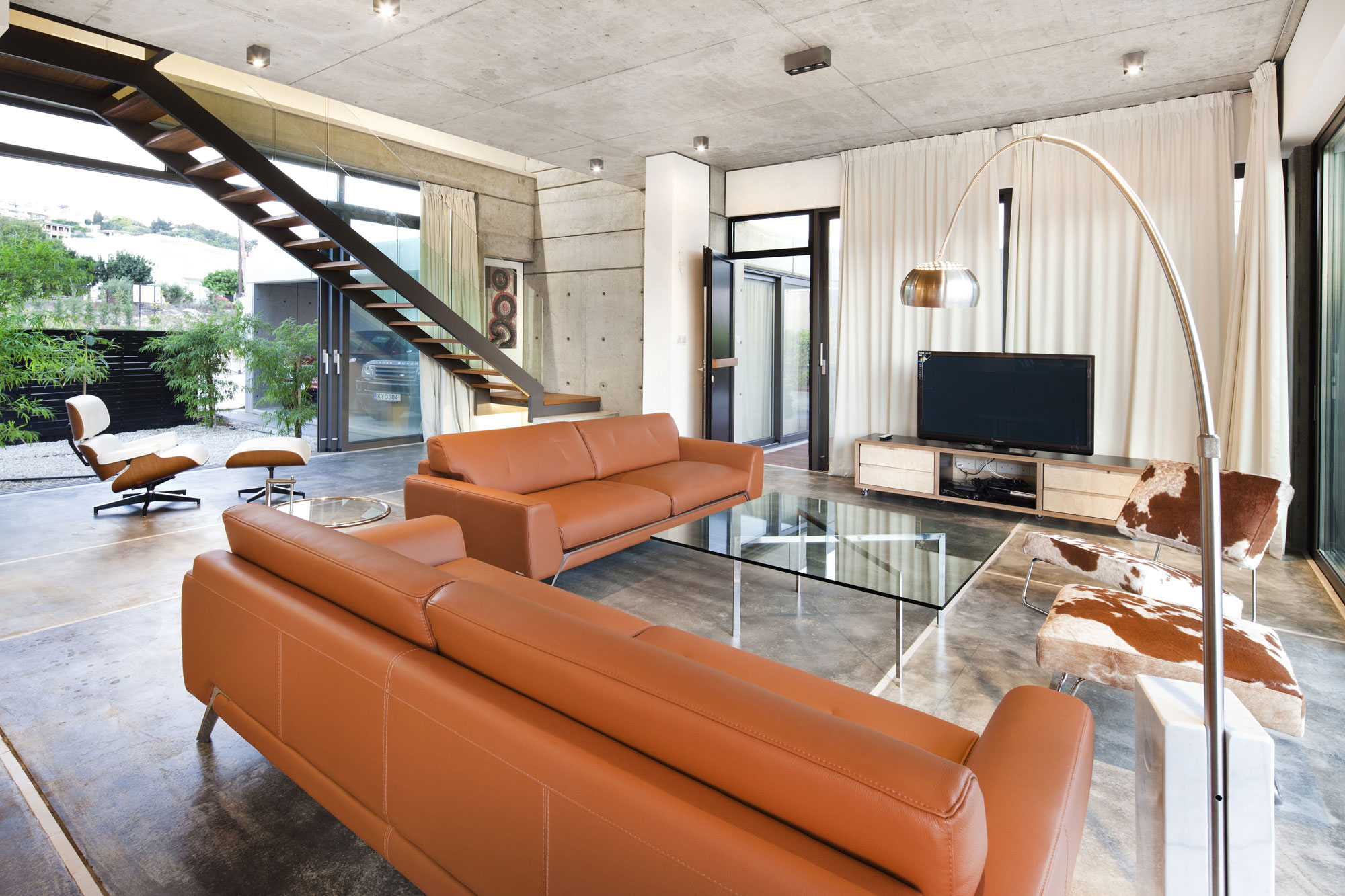 Room Among Brown Sofas Glass Table Also Grey Ceiling Which Is Made From Concrete