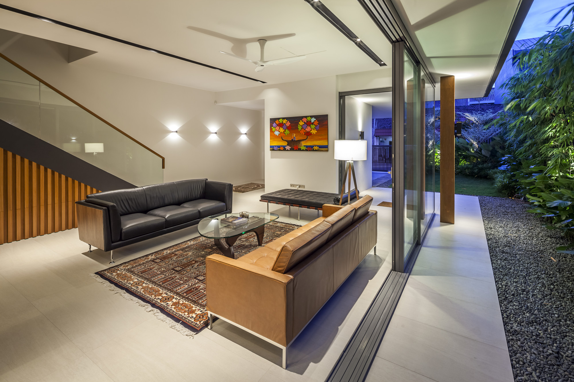 Living Area with Dark Colored Comfy Sofa Along With Bright Clear Lighting From Wall Lamp