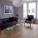 Living Room with Black Sofa Added Near Glass Table On Foor