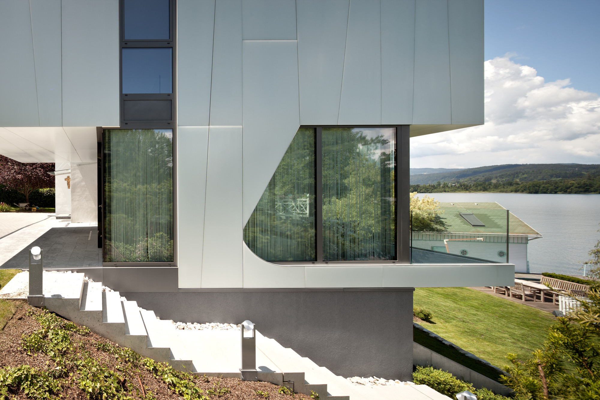 Outdoor Staircase Use Glass Balustrade Along With Rustic Landscape Beside It