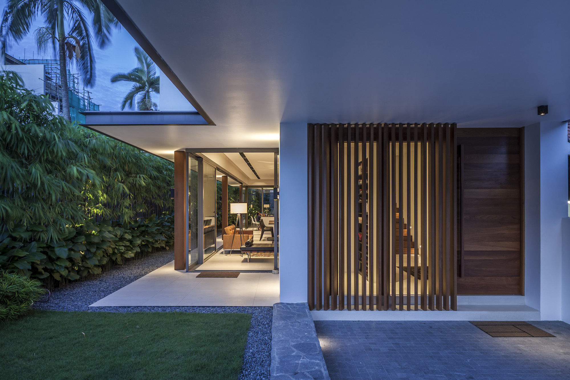 Sunny Side House by Wallflower Architecture + Design - Light Brown Colored Wooden Door Along With Bright Cream Lighting Inside