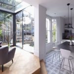 Vase Of Flower On Glossy Grey Countertop Of Kitchen Bar On Wooden Floor
