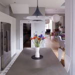 Vase Of Flower On Kitchen Table Under Exclusive Pendant Lamp On Ceiling
