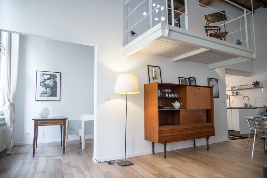 Via delle Orfane by CON3STUDIO - Wooden Cupboard Added Near Floor Lamps On Wooden Board Flooring Decor