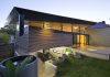 The Mullet – Concrete Driveways in Attractive House Design with Spacious Living Space Green Lawn Also Some Pots Beside Patio Near Colorful Chair